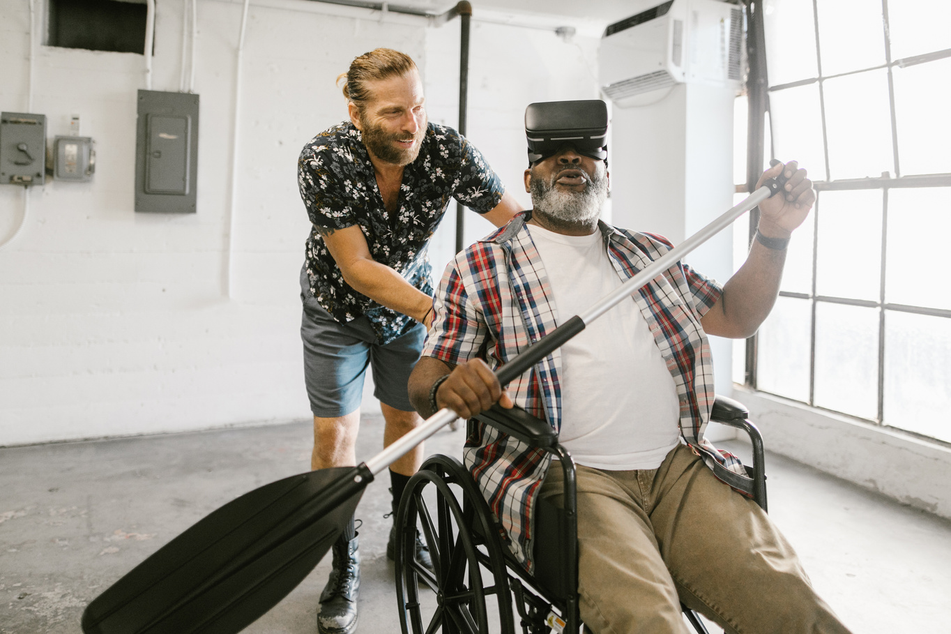 Man Helping a Man Play with Virtual Reality Headset