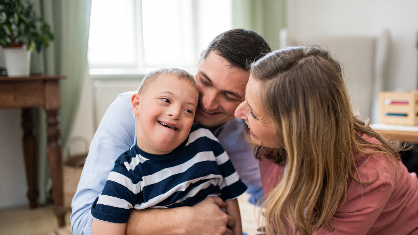 Parents Around Their Son with Down Syndrome 